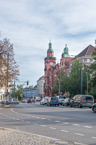 Berlin, Germany - October 3, 2020: Very busy street Breite Strasse, Pankow town hall with its clock tower faced with red bricks and typical for the district of Pankow old town houses