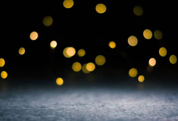 istock Dark background and bright blurred lights from behind. illuminated place in the foreground. 1290917792