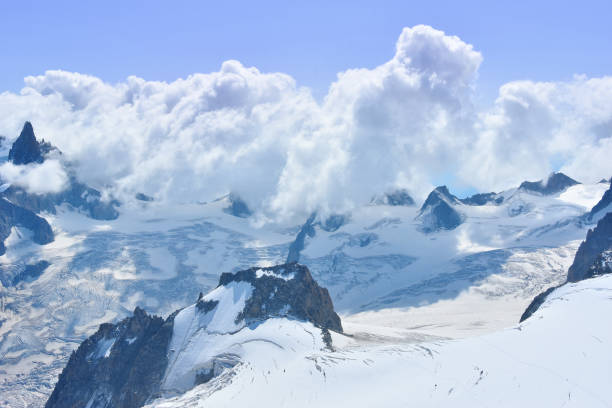 Mont Blanc experience Beautiful blue morning landscape with clouds over alps in Mont Blanc massif from Aiguille du Midi 3842m, Chamonix, France leisure activity french culture sport high angle view stock pictures, royalty-free photos & images