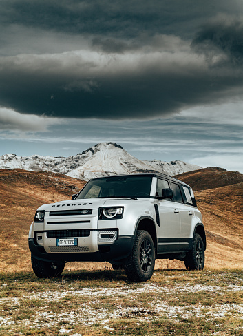 Campo Imperatore, Italy - September 26, 2020 : The New Land Rover Defender 2020 is parked on a wheat field