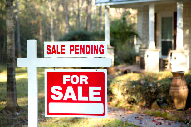 istock Home for sale with real estate sign.  Front yard. 1290924468