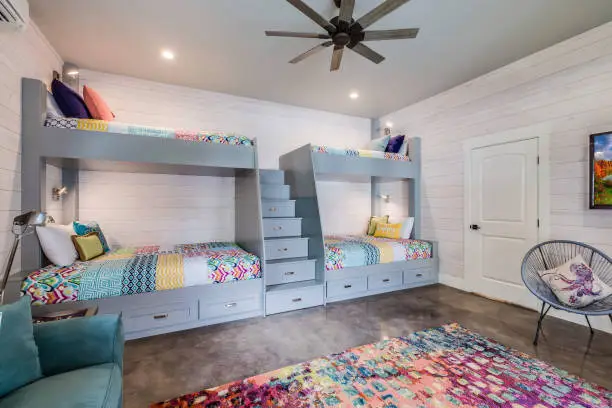Colorful rug and shiplap wall in kids bedroom