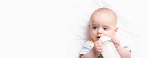istock Baby drinking milk frome bottle. Copy space. 1290931614