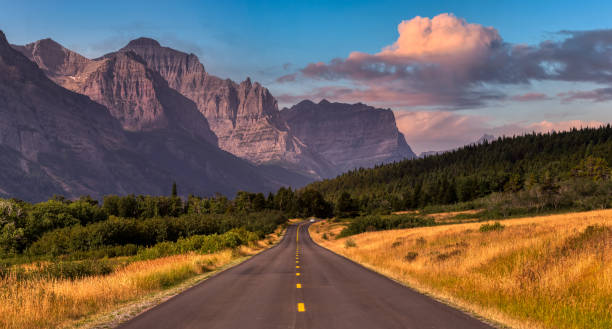 beautiful view of scenic highway with american rocky mountain landscape - dusk blue montana landscape imagens e fotografias de stock