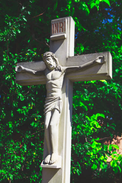 istock Sculpture of Jesus Christ with Cross 1290936747