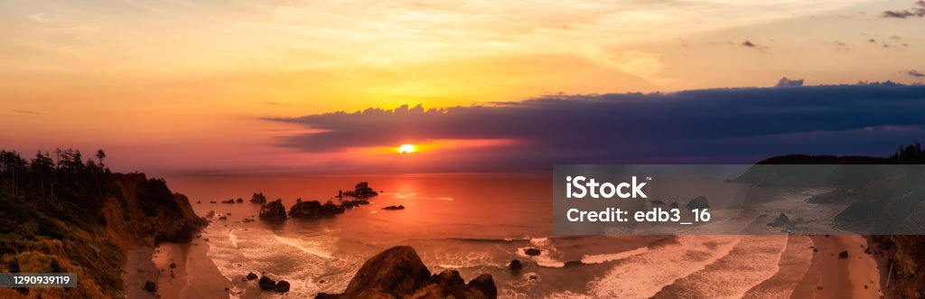 Ecola State Park, Cannon Beach, Oregon, United States Ecola State Park, Cannon Beach, Oregon, United States. Beautiful Panoramic View of the Sandy and Rocky Beach on Pacific Ocean Coast. Dramatic Sunset Sky. Beach Stock Photo