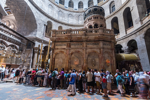 Tourists and pilgrims stand in line waiting to enter Jesus's empty tomb, where he is said to have been buried and resurrected in Church of the Holy Sepulchre,Jerusalem, Israel
