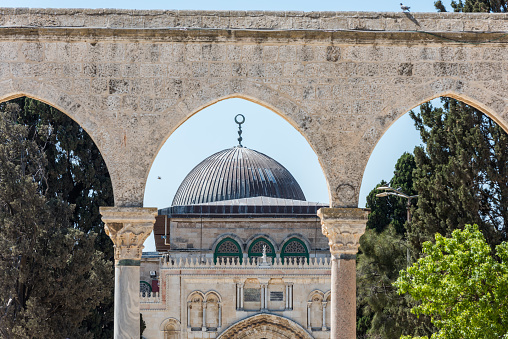 Arched South gateway with Siliver dome of Al-Aqsa Mosque at the square of Golden Dome of the Rock, in an Islamic shrine located on the Temple Mount in the Old City Jerusalem, Israel