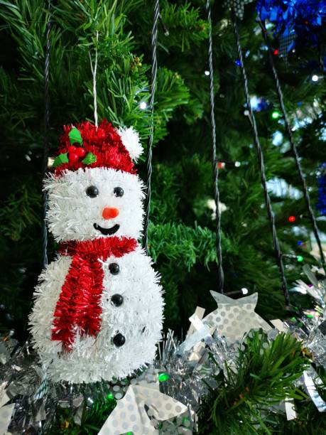 istock Snowman hanging on Christmas tree with Christmas Decoration. 1290946738