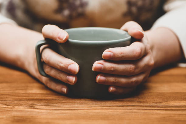 istock Young woman drinking hot cocoa or coffee 1290948153
