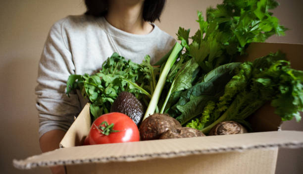 istock Delivery of assorted vegetables in cardboard boxes 1290953230