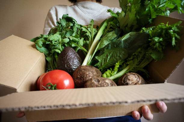 istock Delivery of assorted vegetables in cardboard boxes 1290953236