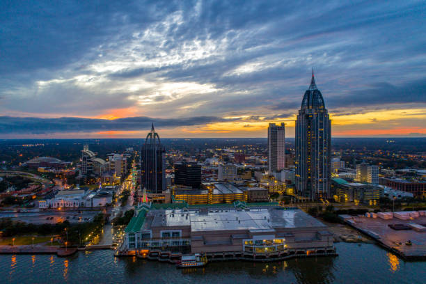 Mobile waterfront skyline at sunset The downtown Mobile, Alabama riverside skyline at sunset alabama stock pictures, royalty-free photos & images