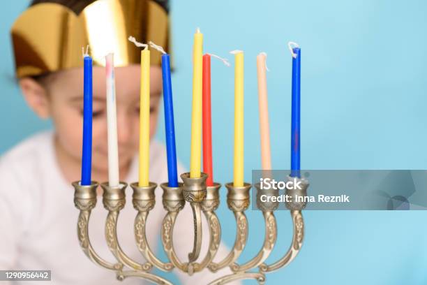 Little Jewish Boy Puts Candles On Traditional Menorah Stock Photo - Download Image Now