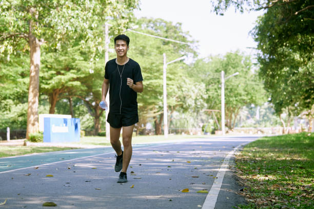 istock A man jogging holding a water bottle in the park 1290960523