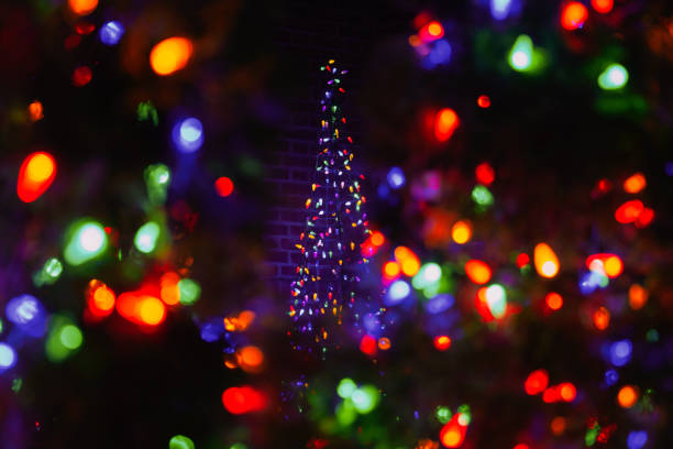 Christmas tree circle lights bokeh, blurred, out of focus effect, colorful lighting on dark background, night