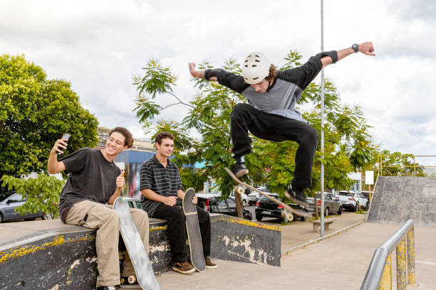 istock Friends doing maneuver in skate park 1290963194