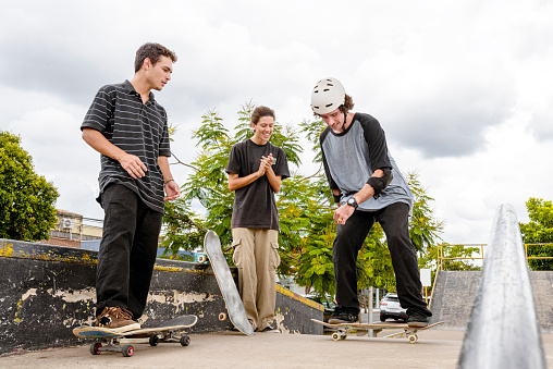Young people cheering for a successful maneuver. Skateboarding