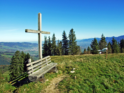Christian crucifix on the slopes of a Alpstein mountain range and in the Rhine river valley (Rheintal), Oberriet SG - Canton of St. Gallen, Switzerland