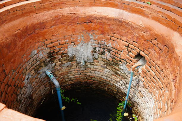 istock Thai ancient wells There are blue water pipes and red brick edges. 1290967447