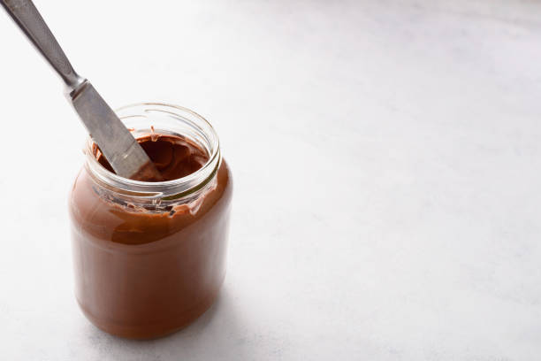 istock Jar of chocolate-nut paste spread and toast with copy space 1290971307
