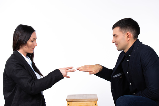 Game battle between a businesswoman and a businessman. The woman wins. Photo on a white background. High quality photo