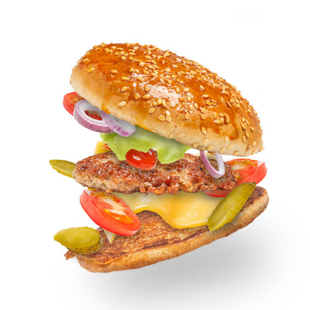 istock Tasty hamburger with flying ingredients on white background. 1290972286