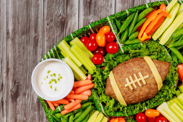 healthy vegetable platter with meatloaf like a football ball for american football game party. close up. - american football football food snack imagens e fotografias de stock