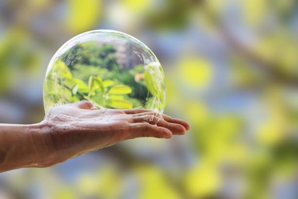 istock Hand of man hold bubble soap suds on palm isolated on blurred background with clipping path. 1290974801