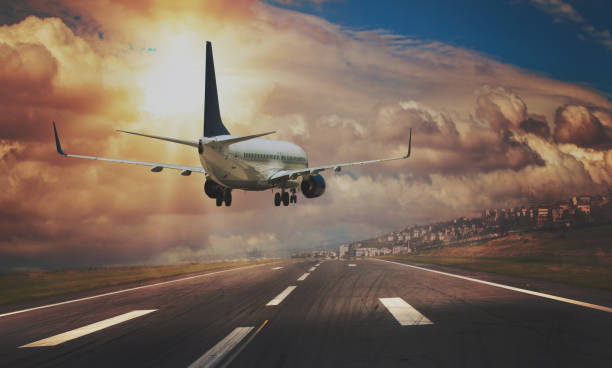 istock Passenger airplane landing at sunset. 1290978840