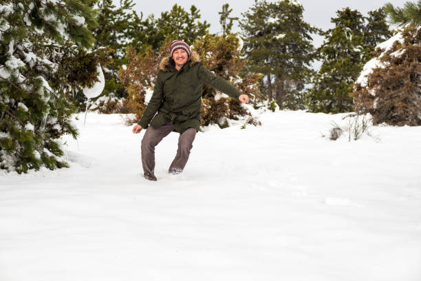 istock man jumping over snow in the forest in wintertime 1290979147