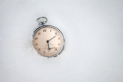 Old pocket mechanical watch isolated on black background. Pocket watch with antique accessory, vintage still life.