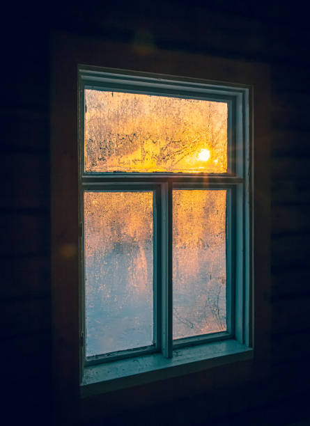 istock Old frozen window and mystical light. 1290982733