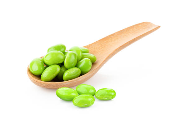 istock green soybeans in wood spoon isolated on white 1290982908