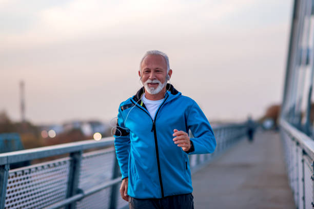 istock Senior man jogging outdoors in the city 1290985696