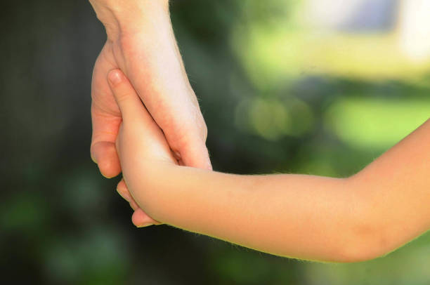 istock child and mother holding hands 1290986738