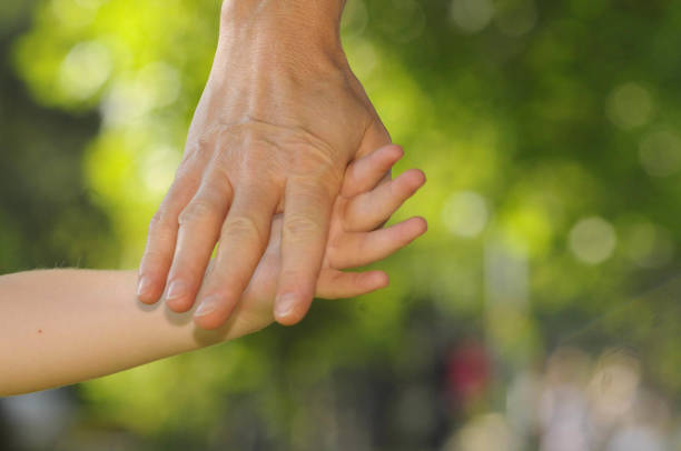 istock child and mother holding hands 1290986760