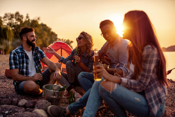 istock Group of friends having picnic on summer day 1290986797