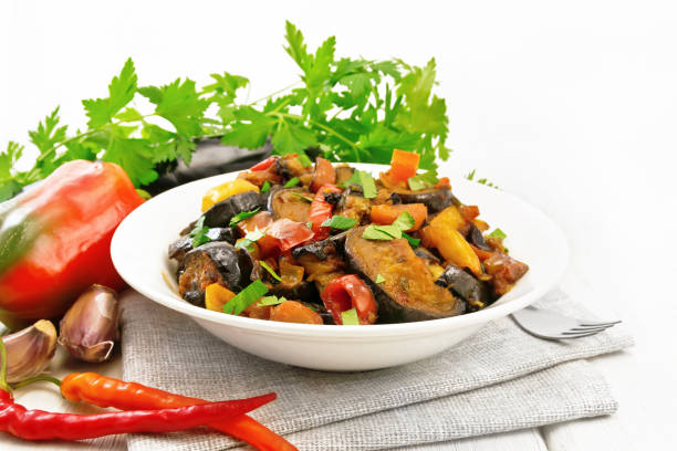 istock Ragout with eggplant and pepper on white board 1290990505