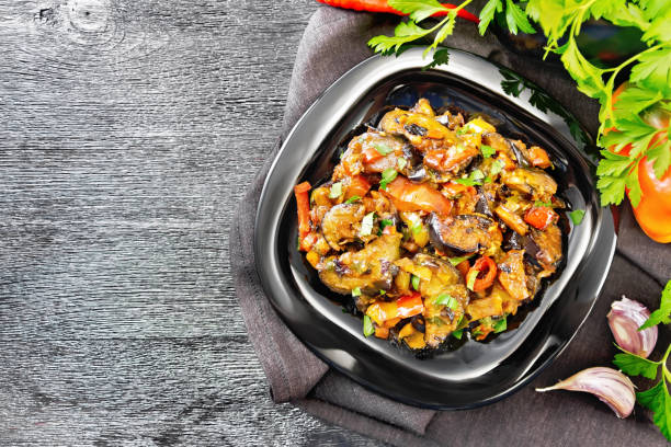 istock Ragout with eggplant and pepper on black board top 1290990515