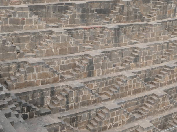 India - Rajasthan - Chand Baori Stepwell - 5 of the 13 Levels in Detail Abhaneri, Rajasthan, India, October 19, 2019: Chand Baori Stepwell – 5 of the 13 Levels in Detail - A close-up of 5 of the 13 levels of the Chand Baori Stepwell with its horizontal, symmetric triangular steps made of sandstone. thomas wells stock pictures, royalty-free photos & images