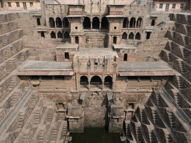 India - Rajasthan - Chand Baori Stepwell – The Haveli Pavilion Head On Abhaneri, Rajasthan, India, October 19, 2019: Chand Baori Stepwell – The Haveli Pavilion Head On - A front, aerial view of the Chand Baori Stepwell haveli pavilion and some of the resting room used by the royals. thomas wells stock pictures, royalty-free photos & images