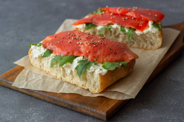 istock Open sandwiches with salmon, arugula and white cheese. Healthy eating. 1290991486