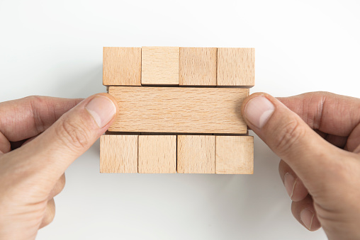 Businesswoman with wooden blocks.