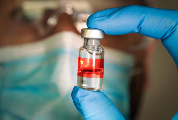Close-up of medical vial with the Chinese flag and blurred doctor on the background. stock photo