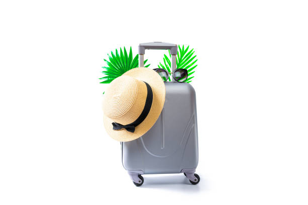 istock Summer pattern background. Suitcase, sunglasses with palm leaves and straw hat in travel composition isolated on white background. Design of summer vacation holiday with copy space. 1290992747