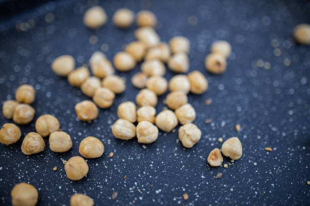 istock Chickpeas scattered on a black tray with white dots 1290993123