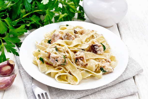 istock Pasta with salmon and cream on wooden board 1290994432