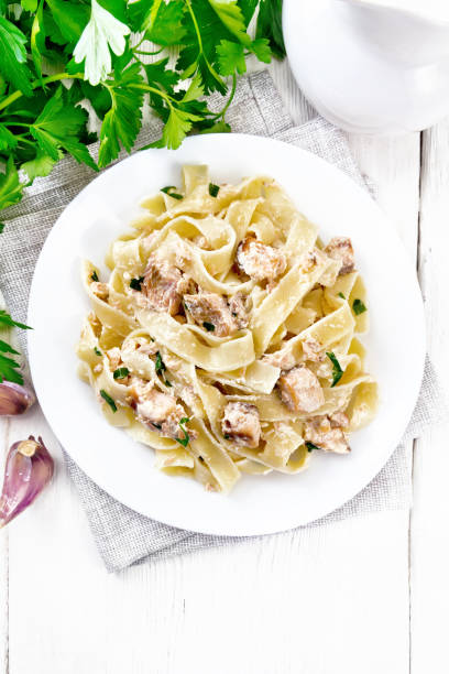 istock Pasta with salmon and cream on light board top 1290994433