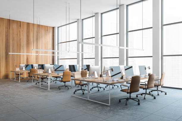 istock Open space office with leather chairs and computers on the table, no people 1290994437
